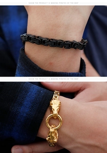 Detail of black Byzantine chain and golden lion head bracelet on male wrist