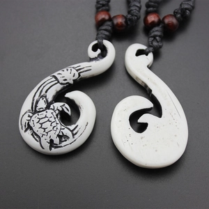 Maori style faux bone fish hook pendants with turtle carving on black woven cord