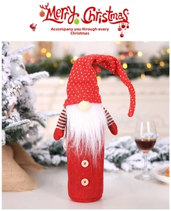 Macro detail of gnome wine bottle cover with red knit hat and white beard decoration