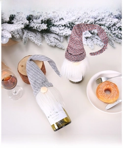 Detail of Christmas gnome wine bottle covers with knitted long hats and white faux fur beards