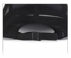Detail of adjustable buckle and elastic strap on black mesh sun hat for outdoor wear
