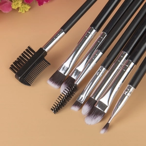 Detail of 8 makeup brushes with black handles and synthetic bristles for eye and brow