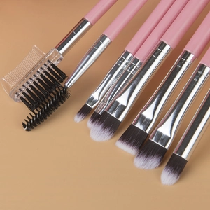 Detailed view of pink makeup brushes with dense synthetic bristles and silver metal ferrules