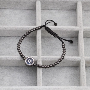 Detailed view of evil eye bracelet with blue zircon inlay and adjustable woven cord