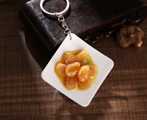 Macro shot of realistic artificial abalone food model on a plate with keychain ring