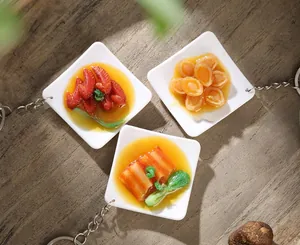 Detailed view of realistic PVC food keychains with miniature Chinese dishes and metal chains