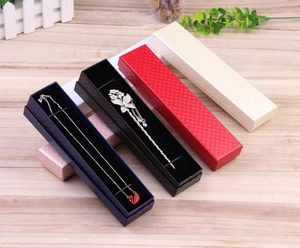 Detail view of rectangular kraft jewelry boxes in multiple colors with textured surface