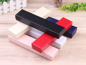 Macro detail of multi-color rectangular jewelry gift boxes with textured rhombus patterns