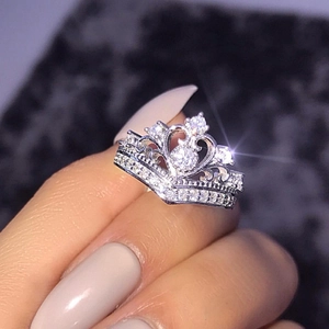 Detailed close-up of a crown-shaped ring with 18K plating and brilliant cubic zirconia