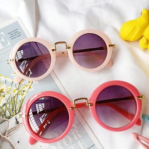 Kids round frame UV400 sunglasses with metal bridge on white fabric background