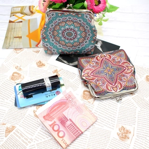Detailed shot of ethnic coin purses with mandala patterns and retro metal clasps