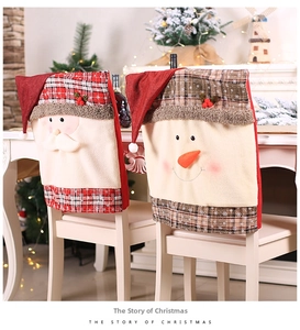 Close-up of Santa and Snowman chair covers with red plaid fabric and berry accents