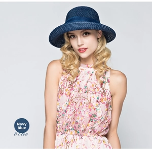 Navy blue woven sun hat with ribbon bow detail worn with floral dress summer look