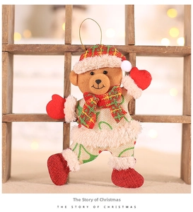 Close-up of burlap Christmas bear ornament with red plaid hat and soft plush trim