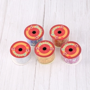 Five rolls of decorative Christmas ribbons with gold star patterns in mixed colors