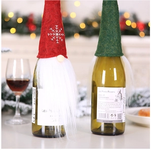 Detail of plush Christmas gnome wine bottle covers with faux fur beard and knit caps