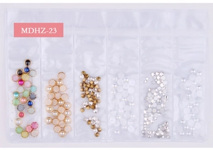Detail of 6-grid nail art kit with assorted rhinestones, pearls and metallic charms