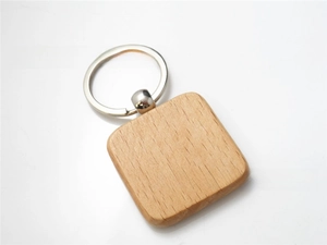 Macro detail of square beech wood keychain with clear natural grain and polished steel ring