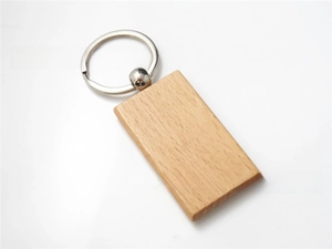 Detail of rectangular beech wood keychain with clear natural grain and silver metal ring