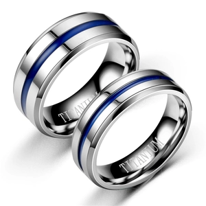 Detailed macro view of silver titanium steel rings featuring blue striped resin inlay