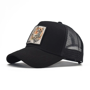 Detail of black mesh trucker hat featuring embroidered tiger patch with TIGER text