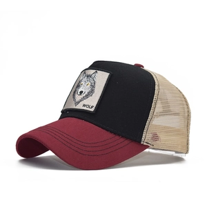 Detail view of cotton trucker hat featuring realistic wolf embroidery patch on front