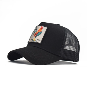 Detail of a black trucker hat featuring a colorful rooster embroidery patch on the front
