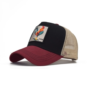 Detail of embroidered rooster patch on a burgundy and black mesh trucker hat