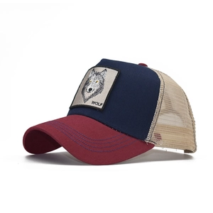 Close-up of embroidered wolf patch on a tricolor breathable mesh trucker cap