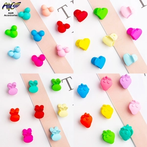 Close-up of candy-colored hair clips set in Mickey, heart, rabbit and strawberry shapes