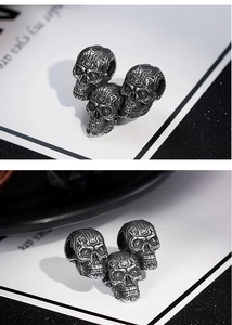 Macro detail of retro skull pendant showing fine metallic textures and dark gray finish