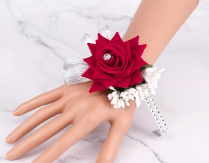 Detail of red rose bridal wrist corsage with sparkling rhinestone and silver sequin band
