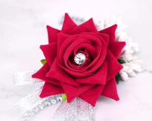 Macro shot of bridal wrist corsage with burgundy velvet rose and crystal accents