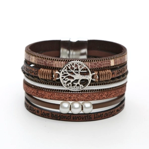 Detail of brown leather multi-layer wrap bracelet with Tree of Life charm and white pearls