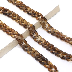 Macro detail of amber tortoise shell acrylic glasses chain with vintage oval link design