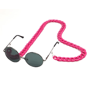Detailed view of pink acrylic glasses chain attached to round black sunglasses