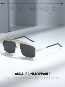 Macro detail of gold metal aviator sunglasses frame with sleek double bridge design