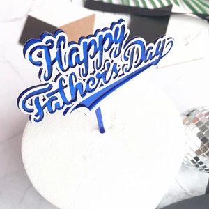 Blue Happy Father's Day acrylic cake topper with silver edge on white dessert