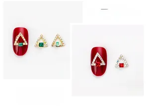 Close-up of gold and silver triangle nail charms with square rhinestones and AB crystal edge