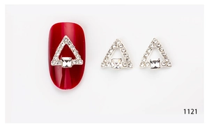 Macro shot of 3D triangle nail charm with square rhinestones and pavé crystal border