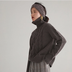 Detail of soft cable knit headband in dark coffee color for winter warmth and style