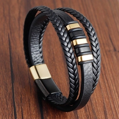 Detail of multi-layer black braided leather bracelet with golden magnetic clasp
