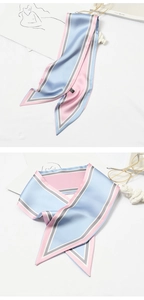 Detail showing blue and pink striped silk scarf styled with glasses and sketchbook