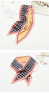 Detailed view of long polka dot twilly silk scarf with vintage yellow and navy patterns