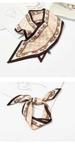 Detail of a beige silk scarf with chain print tied in a bow on a stylish magazine
