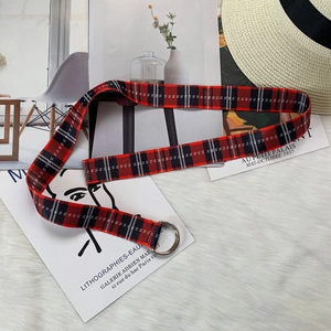 Detail of red and black checkered nylon canvas belt with silver double D-ring buckle
