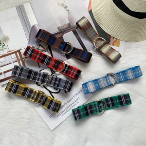 Checkered nylon canvas belt with double D-ring buckles in multiple colors on plush background