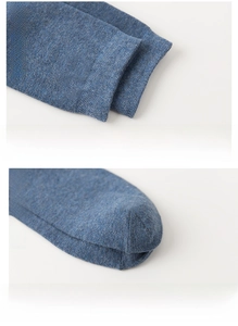 Detail of blue knit cotton crew socks featuring elastic cuffs and reinforced seamless toes