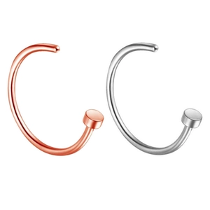 Detailed view of silver and rose gold C-shaped stainless steel nose hoops on white background
