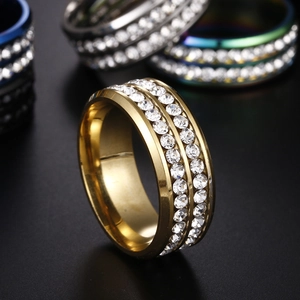 Macro shot of double-row cubic zirconia inlay on a polished gold-plated stainless steel ring